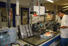 Le laboratoire est divisé en plusieurs ateliers. Ici, la partie des verres organiques où plusieurs opérateurs, capables de réaliser un verre de A à Z, s’occupent du surfaçage des verres, de l’ébauchage, au doucissage et au polissage. ©Acuité 2014
